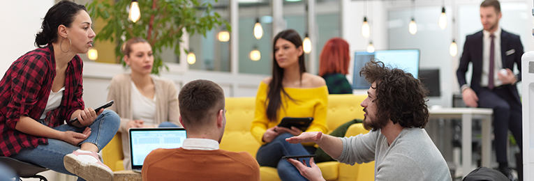a group of people seen at a casual discussion at a office space